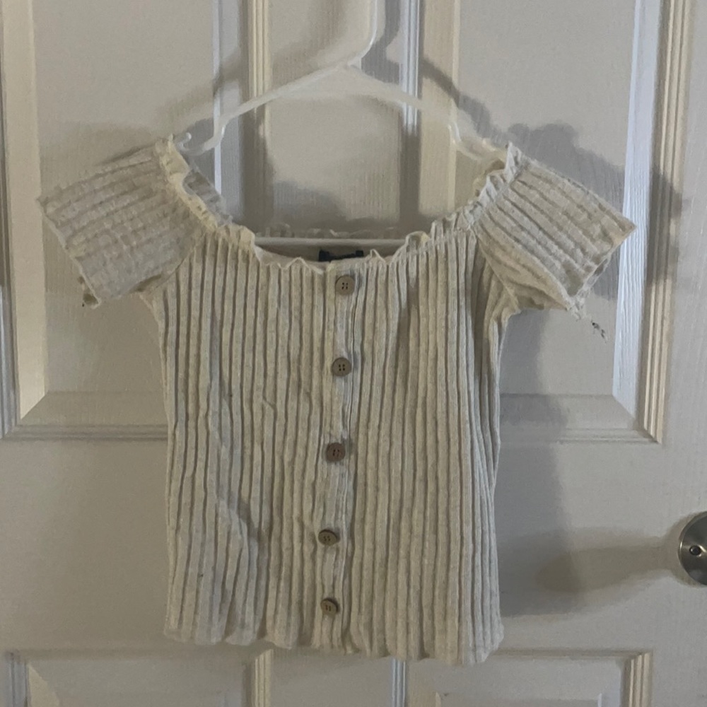 This is a cream colored crop top from rue-21.